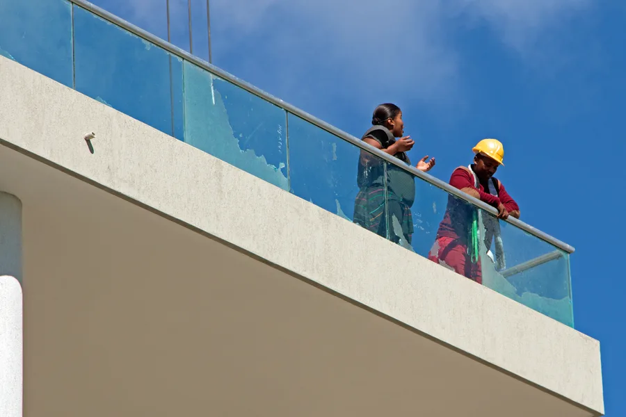Construction workers on the balcony of a building under development